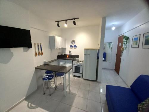 a kitchen with a table and chairs in a room at Apartamento 120 metros da praia in Guarapari