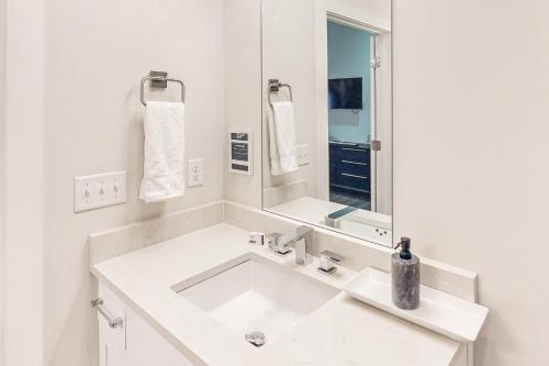 a white bathroom with a sink and a mirror at Country Classic at West End Living, Unit #203 in Nashville