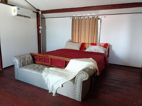 a bedroom with a bed and a couch in it at Star house Seaview Lanta old town in Ko Por