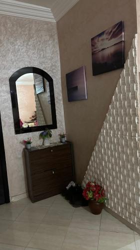 baño con espejo en la pared y tocador en appartement familiale, en Meknès