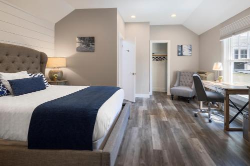 a hotel room with a bed and a desk and a table at Airlie in Warrenton