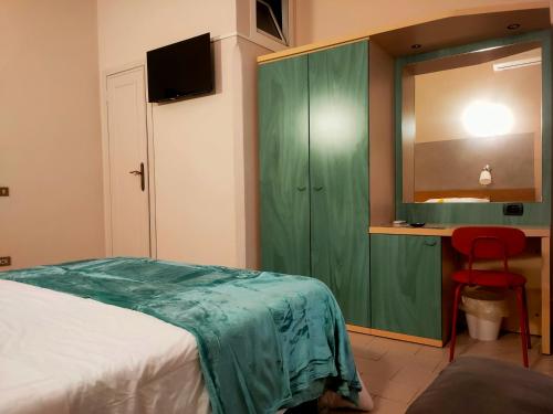 Ένα ή περισσότερα κρεβάτια σε δωμάτιο στο Hotel Il Boschetto