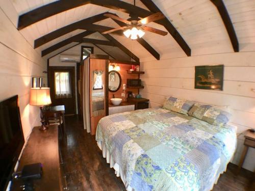 a bedroom with a bed and a ceiling fan at Tiny Home Cottage Near the Smokies #10 Helena in Sevierville