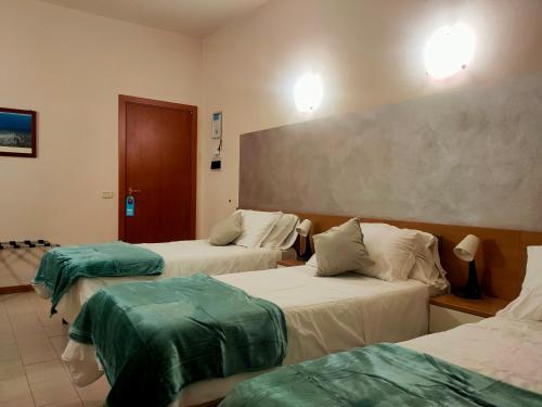 Ένα ή περισσότερα κρεβάτια σε δωμάτιο στο Hotel Il Boschetto