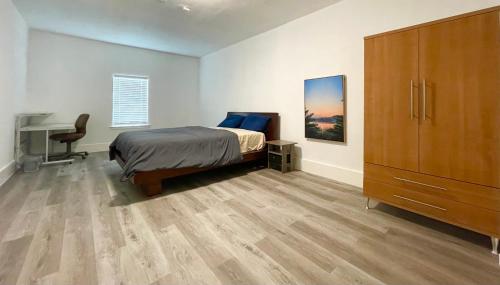 a bedroom with a bed and a desk and a dresser at Private room in Dallas near downtown in Dallas