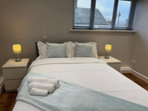 a bedroom with a large bed with towels on it at Rest Haven Lodge in Kettering