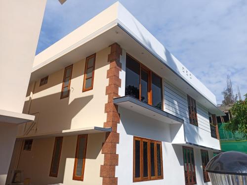 a white building with windows and a balcony at Casa Branca Retreat in Varkala