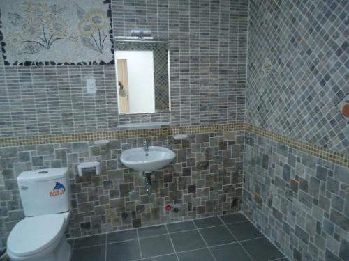 a bathroom with a toilet and a sink at Two Bedroom Villa in Ho Chi Minh City