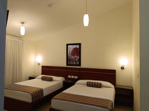 Ένα ή περισσότερα κρεβάτια σε δωμάτιο στο Grand City Hotel Cancun