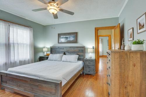 a bedroom with a bed and a ceiling fan at Pet-Friendly Omaha Vacation Rental with Deck! in Omaha