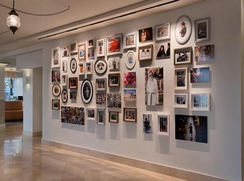 a wall of pictures on a wall in a room at Prima Kings Hotel in Jerusalem