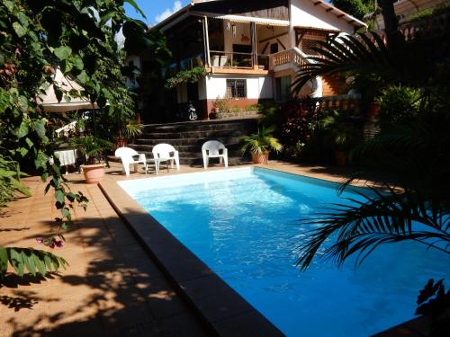 a swimming pool in front of a house at Sarl Mayoume in Mamoudzou