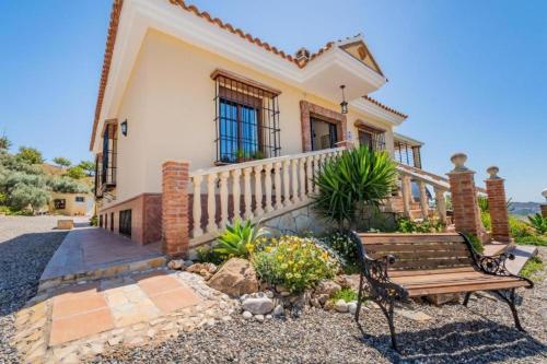 a house with a bench in front of it at finca mallorquin in Málaga