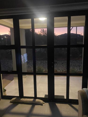 a window with a view of a sunset seen through it at Pule's Home in Maseru