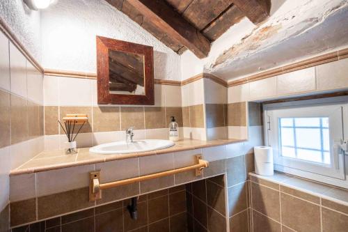 a bathroom with a sink and a window at Molino de Gris Cazorla in Chilluévar