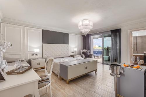 a living room with a bed and a dining room at Hotel Buratti in Cervia