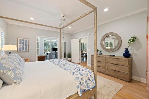 a bedroom with a large bed and a mirror at 23 Ocean Green in Kiawah Island