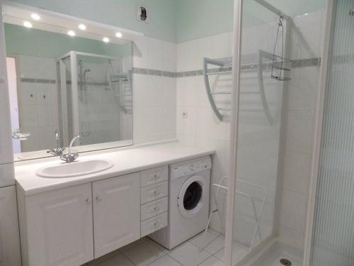 La salle de bains est pourvue d'un lavabo et d'un lave-linge. dans l'établissement Royan - Résidence VILLA BRACELLI - APPARTEMENT SPACIEUX - Centre-ville, à Royan