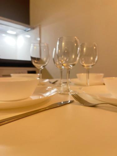 quatre verres à vin vides assis sur une table dans l'établissement T2D Apartment - Suite BLG proche Disneyland Paris, à Bussy-Saint-Georges