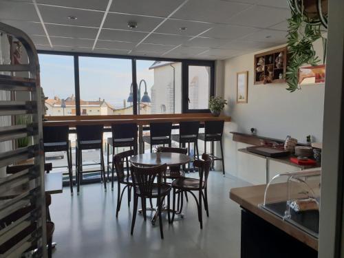 een eetkamer met een tafel en stoelen bij Auberge Communale de la Fruitière in Péron