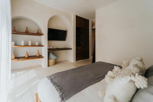 a bedroom with a bed with a stuffed animal on it at Villa Viento 4br 8pp Private Pool Rooftop Security in Tulum