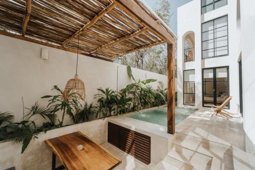 an indoor pool in a house with a wooden ceiling at Villa Viento 4br 8pp Private Pool Rooftop Security in Tulum