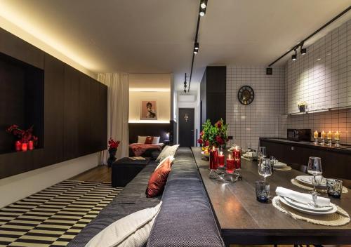 a dining room with a table and a living room at Stylish 1 bedroom studio near Most City in Dnipro