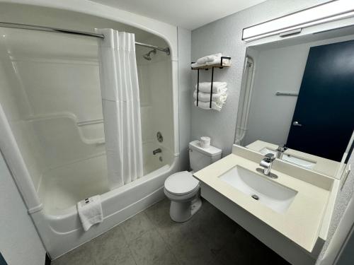 a bathroom with a sink and a shower and a toilet at Studio 6 Suites East Syracuse NY Airport in East Syracuse