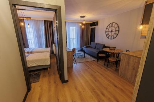 a living room with a couch and a table in a room at Apartamenty DeLux Centrum Kielce in Kielce