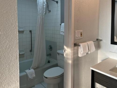 a bathroom with a toilet and a tub and a sink at Motel 6 Port Lavaca, TX in Port Lavaca