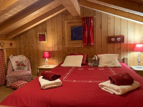 a bedroom with a large red bed in a room at Chalet Cocoon vue MontBlanc in Saint-Gervais-les-Bains