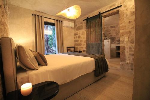 a bedroom with a bed and a large window at Villa Cornelia, Ponte de Lima in Ponte de Lima
