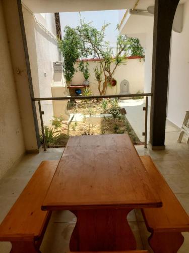 a wooden table in a room with a view at Omnia House in Monastir