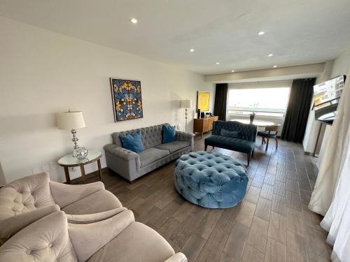 a living room with a couch and a table at Suites Rio Elba in Mexico City