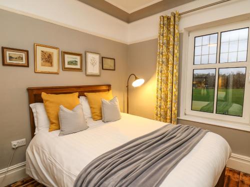 a bedroom with a large bed and a window at Tirallen in Llanwrda
