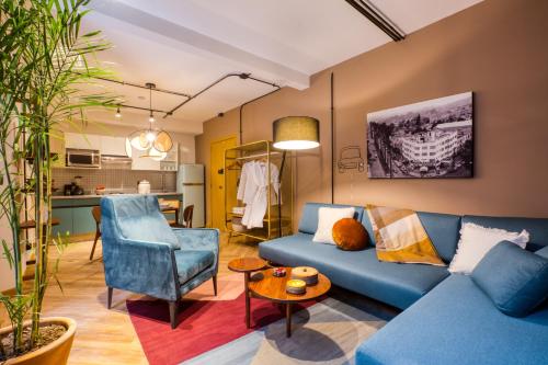 a living room with a blue couch and a table at Casa Miravalle in Mexico City