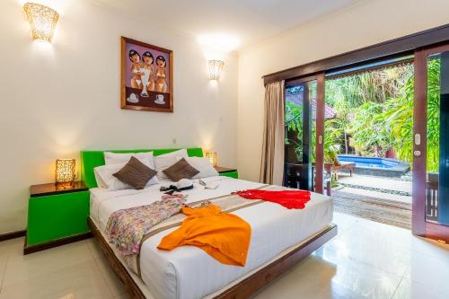 a bedroom with a large bed and a large window at Senang Luxury Villa in Gili Islands