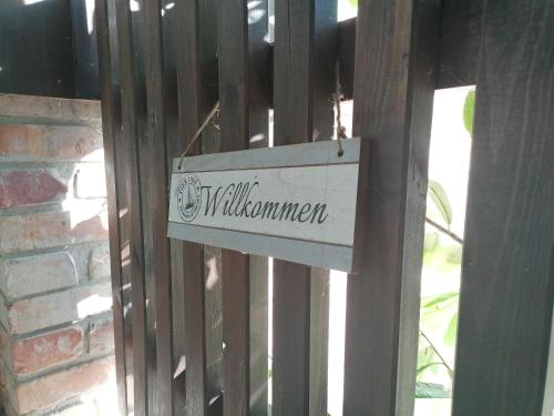 a sign that says twillowship on a fence at Ferienwohnungen Alter Bahnhof mit Terrasse und Garten OFC 06 in Roggow