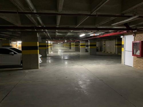 an empty parking garage with a car parked in it at Apartamento nuevo norte Cali in Cali
