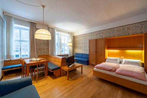 um quarto com uma cama e uma sala de jantar em Grand Hotel Carezza Multiproprietà em Carezza al Lago