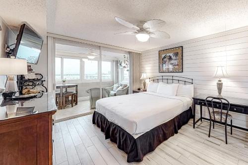 a bedroom with a bed and a television in it at Jetty East Condos in Destin