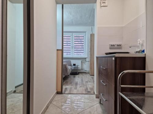 a kitchen with a door leading into a room at Cozy apartments in the center of Liepaja in Liepāja