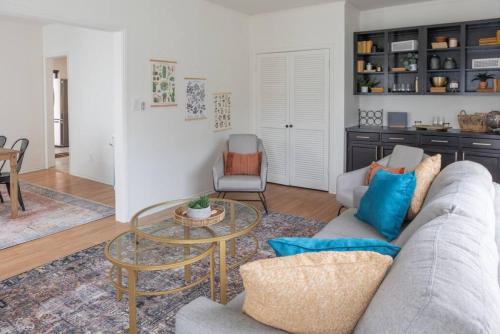 a living room with a couch and a table at Wyndams Foresight Quaint Abode Near Everything in Tulsa