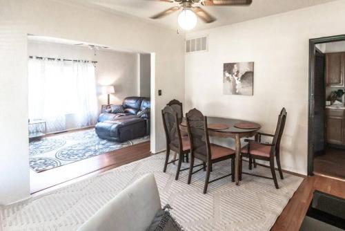 a living room with a table and chairs and a couch at Trailside Retreat in the City in Tulsa