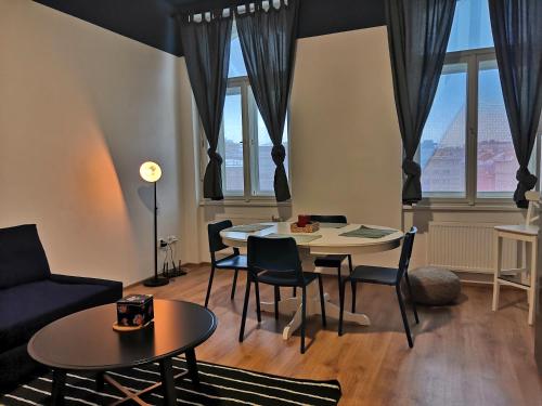 a living room with a table and chairs at Brand new apartments and hostel in center in Prague