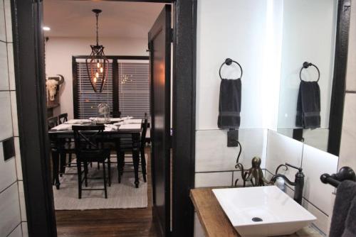 a kitchen and dining room with a table and a mirror at Bison Flat - Redefined Urban Luxury in Tulsa