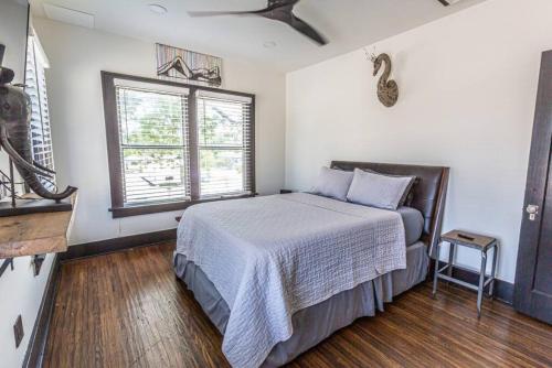 a bedroom with a bed and a window at Bison Flat - Redefined Urban Luxury in Tulsa