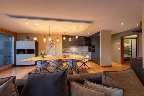 a kitchen and dining room with a table and chairs at Chalet Apartments Iseltwald in Iseltwald