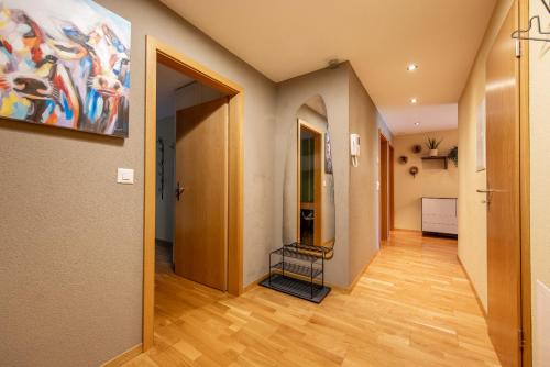 a hallway with a painting on the wall at Chalet Apartments Iseltwald in Iseltwald