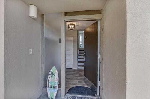 a surfboard leaning against a wall next to a door at 1172 Beach Walker in Amelia Island